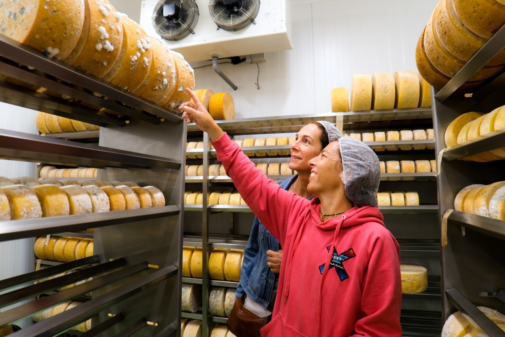  Two girls in a cheese warehouse.