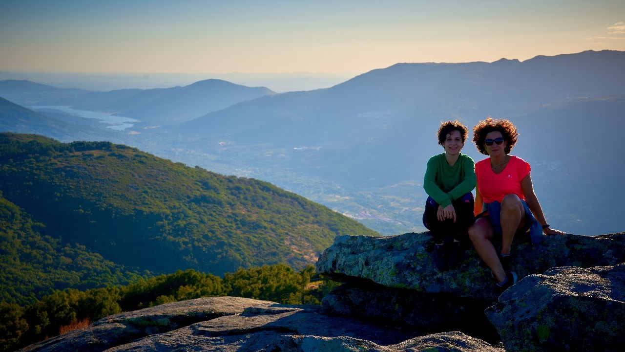 Tourists climbing to the top of the rocky outcrops