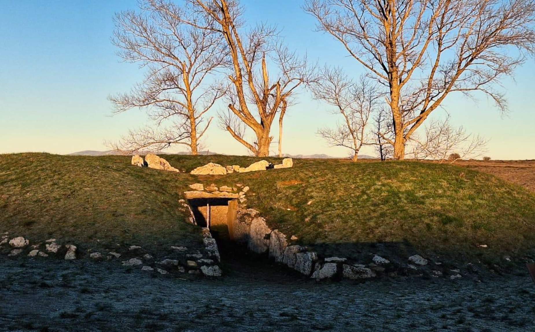 Dolmen in the middle of the park with countryside landscape and trees
