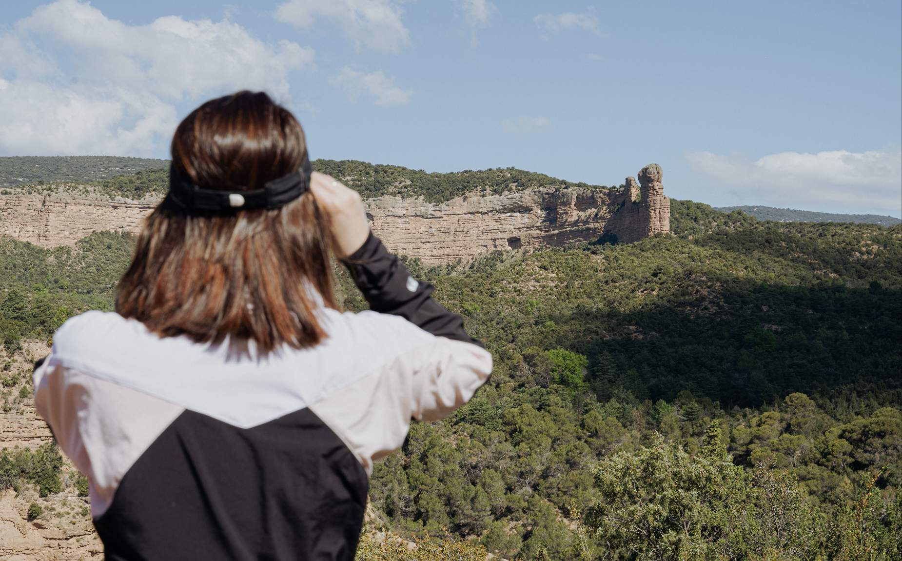 Girl looking through binoculars at the natural scenery