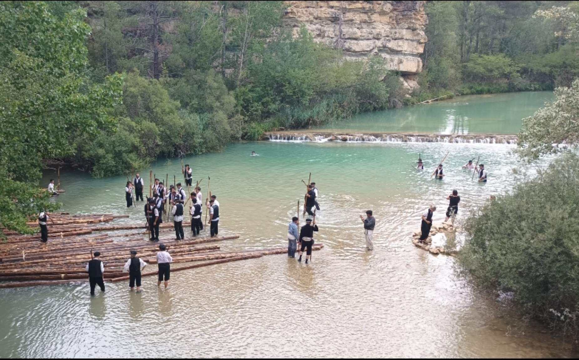 Several people in the river dressed in typical costumes