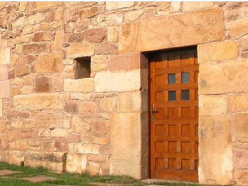 Fachada de piedra con una puerta de madera 